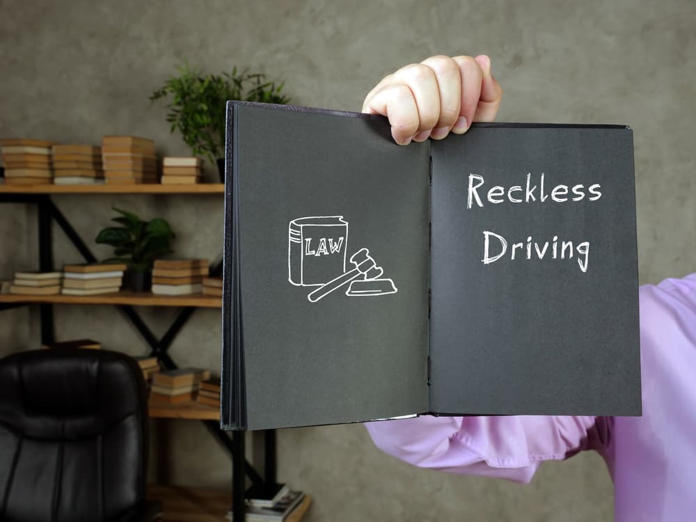 Reckless Driving with phrase on the piece of paper.