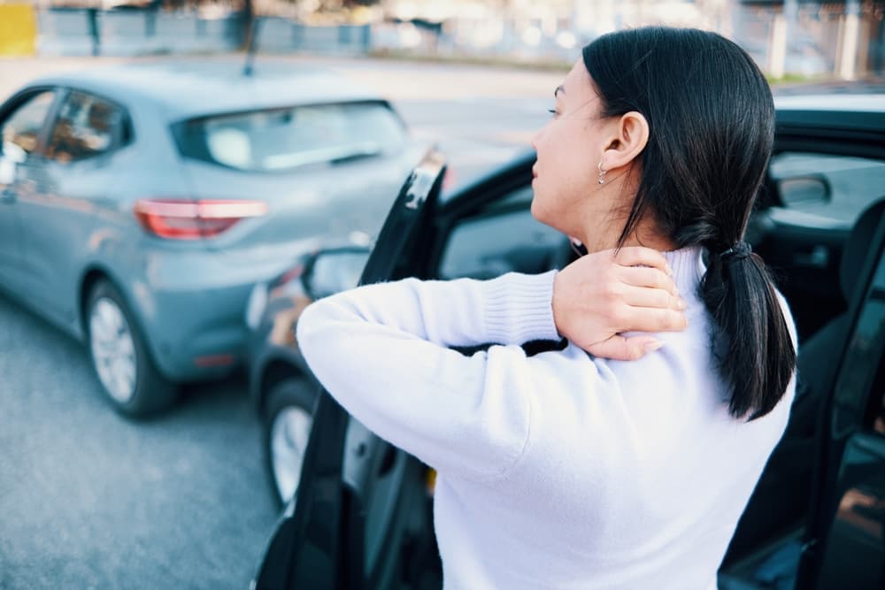 Woman experiencing neck pain following a multi-car accident.