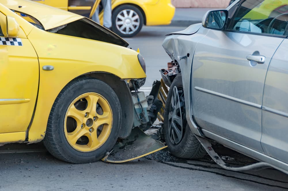 A rideshare car and a private vehicle collided in a crash. Both drivers assess the damage, and concerns about insurance coverage and liability arise.