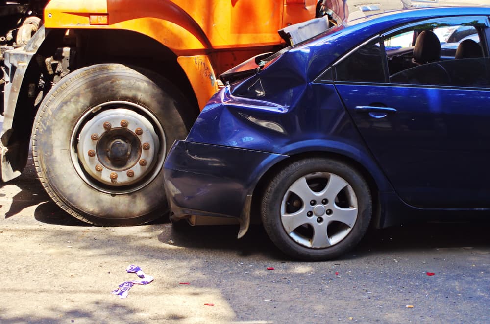 Truck and passenger car collision on the road.